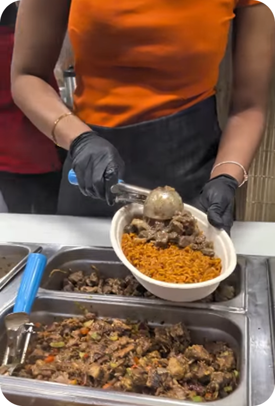 Building a bowl with jollof rice and stewed meat