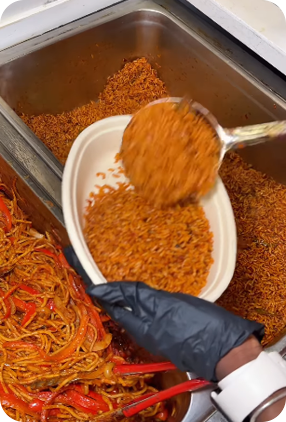 Fresh jollof rice being served into a bowl